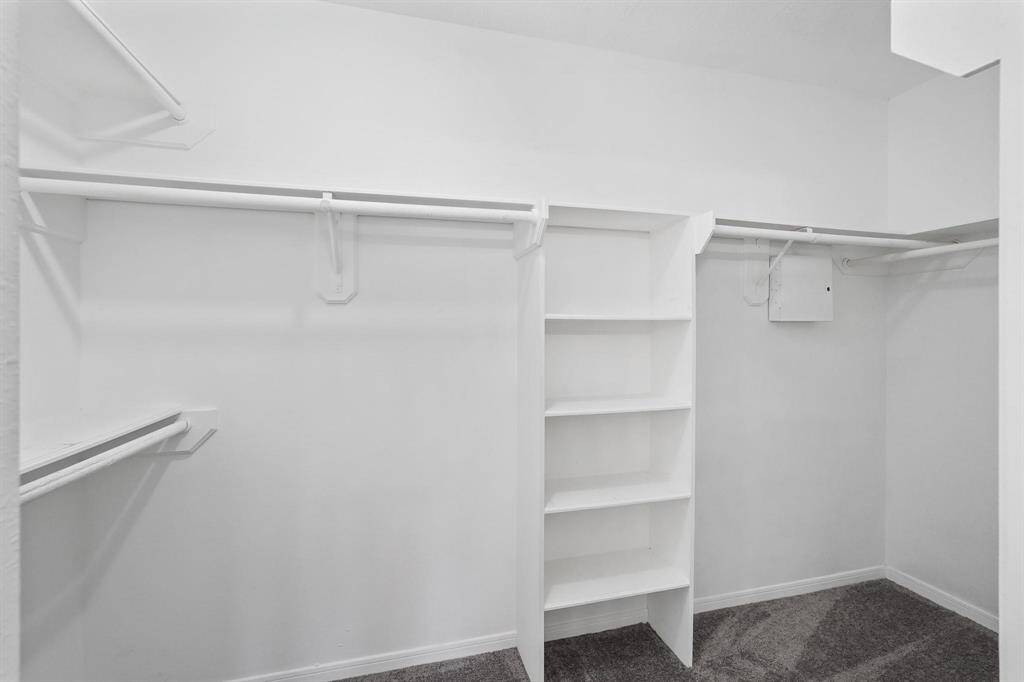 Master Closet with Added Shelving and Double Rods.