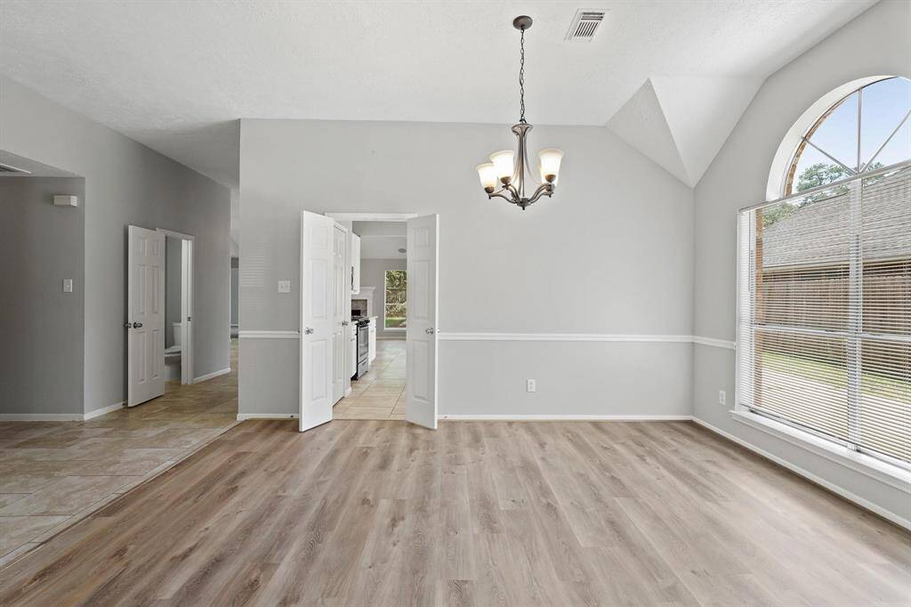 Spacious Dining Room is enhanced with Luxury Vinyl Plank Flooring, Sleek Lighting, High Ceilings and Natural Light.
