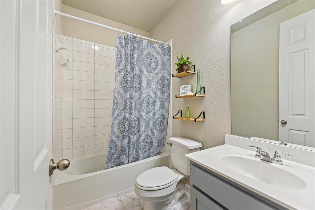 The second full guest bathroom is right off the third bedroom to allow for more privacy and flexibility with your family and guests with beautiful tile flooring.