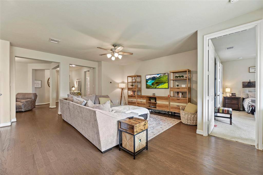 Enjoy movie nights with the family or relaxing after a long day at work in this spacious family room with 9' ceilings and engineered wood flooring.