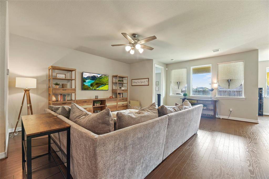 The family room receives lots of natural light from the morning sun with three large windows.