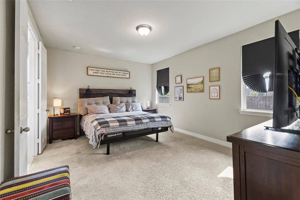 Step into this primary suite that can fit a king bed and two side tables. The bedroom also features double doors into the en-suite bathroom.