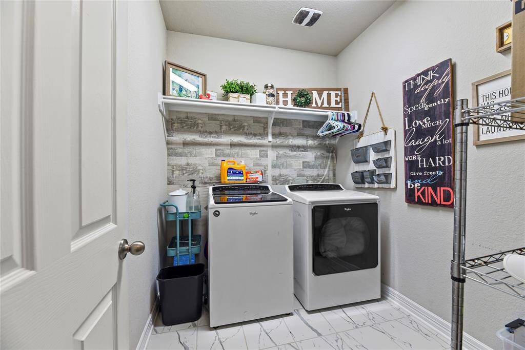 In the front of the home by the garge is a spacious laundry room with beautiful cermaic tile flooring. Washer and Dryer will convey with the buyer!