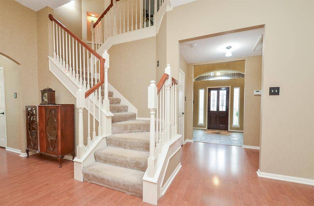 Elegant staircase leading to gameroom and 3 bedrooms with 2 full bathrooms