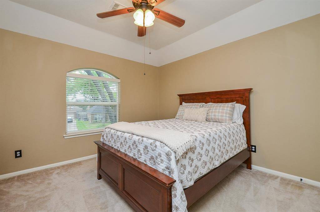 Cozy secondary bedroom with soft beige walls.