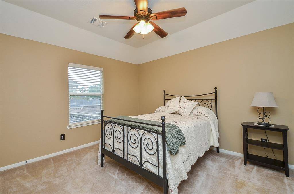This secondary bedroom features neutral walls and a window for natural light,