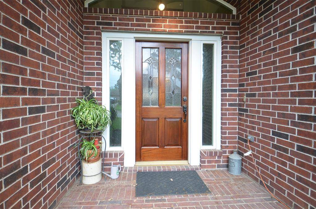 Inviting entryway flanked by sidelights. The brick exterior adds a classic touch,.