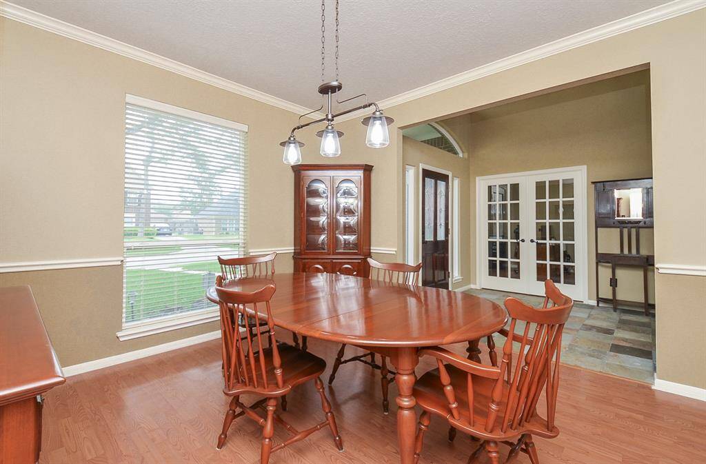 This photo showcases a cozy formal dining room with seamless access to the kitchen area,