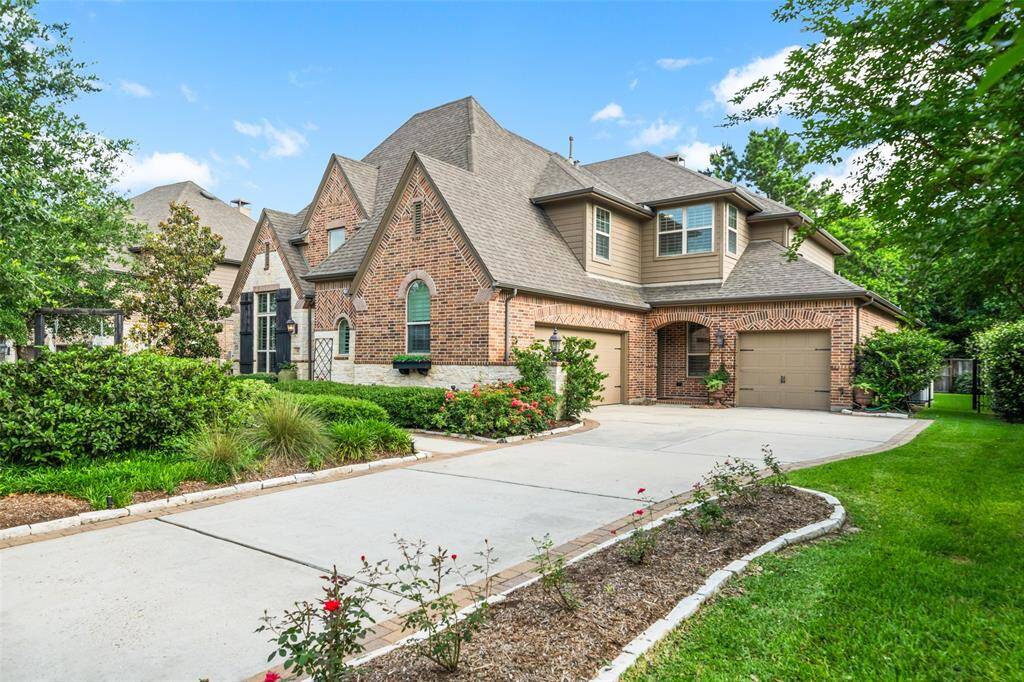 Home features 3 full size garages with epoxy flooring & large driveway allows for lots of extra parking.