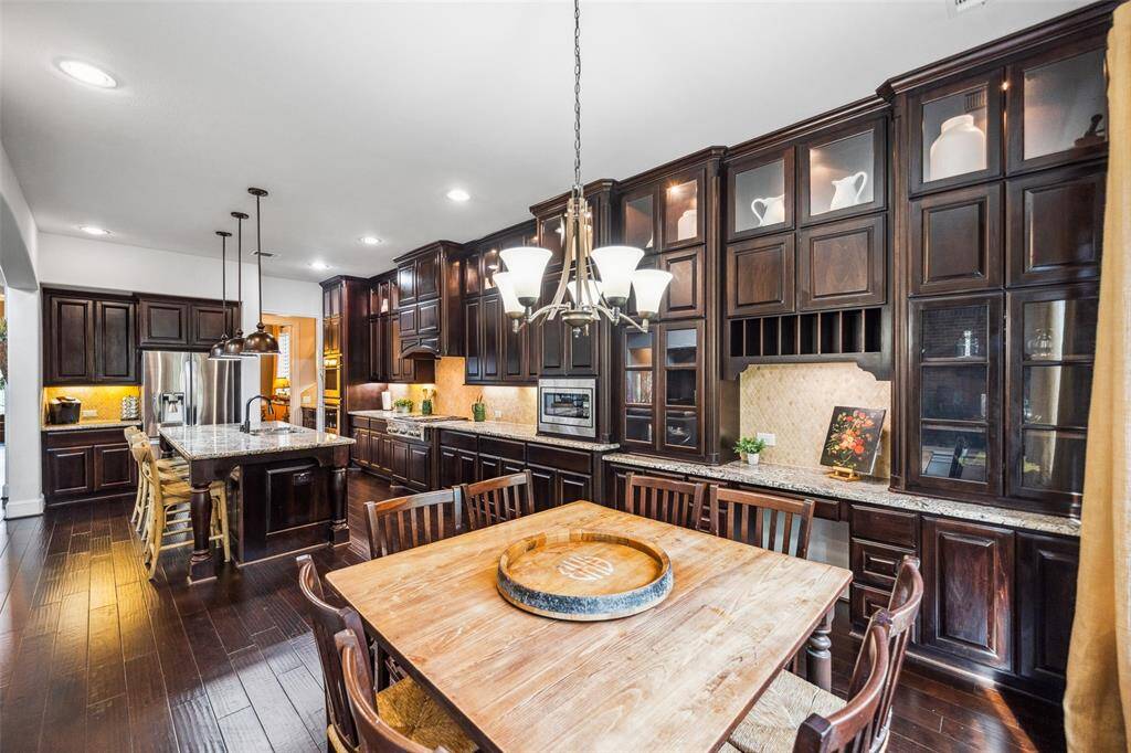 Elegant cabinetry with glass doors and accent lighting creates a stunning display.