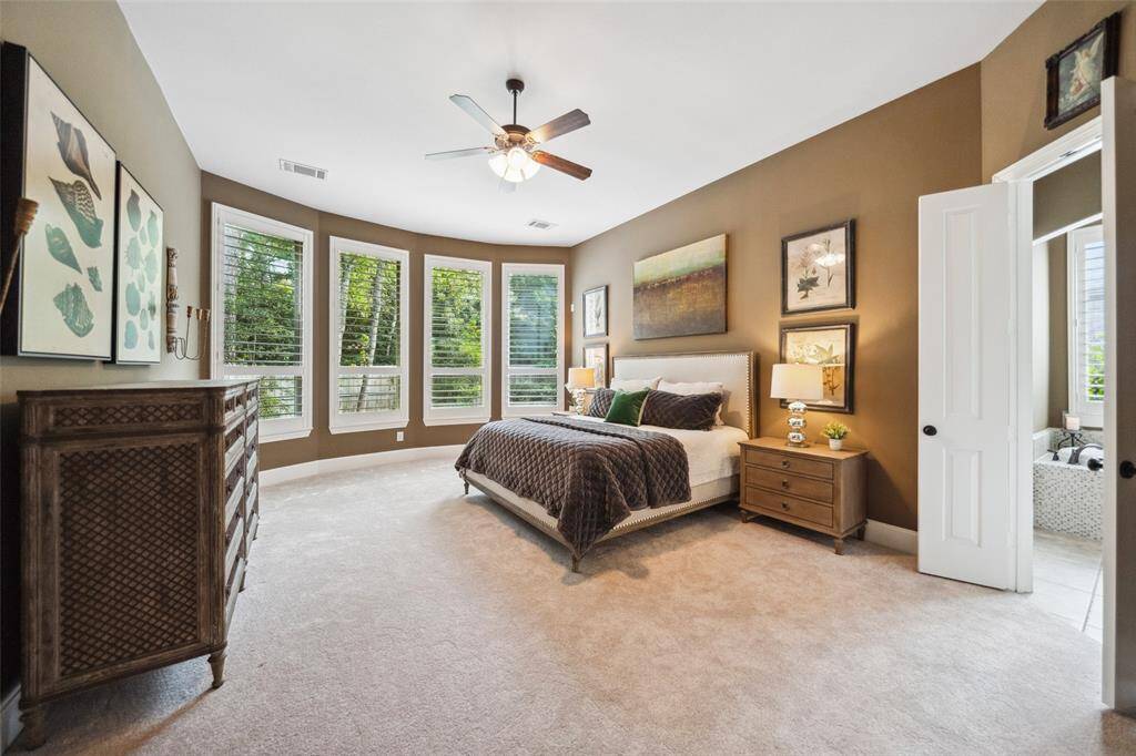 Entrance into an elegant Primary suite featuring relaxing spa retreat, plantation shutters, sitting area & new carpet.