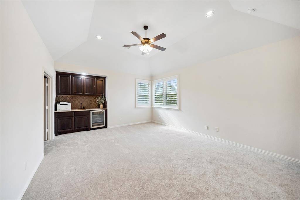 Large upstairs Gameroom features built in granite wet bar with a wine/beverage cooler and lots of storage cabinets.