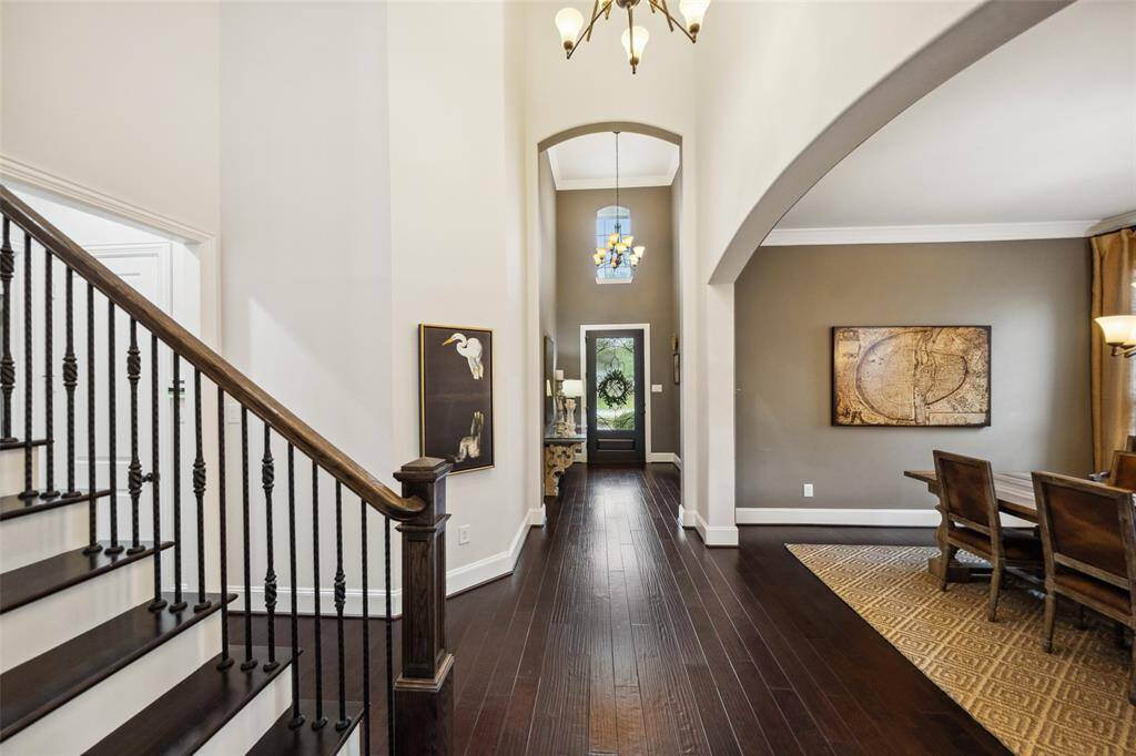 Welcome to a stunning foyer with 20-foot ceilings and elegant designer paint.