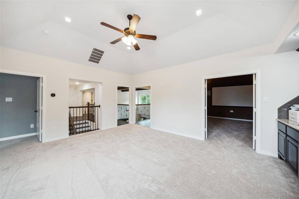 View of entrance into the media room on the right & into private bedroom area with full size ensuite bathroom on the left.