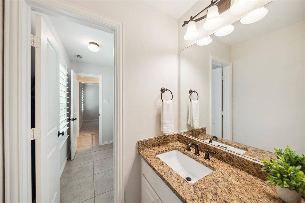 1st vanity of the shared Hollywood bath with the entrance into the shared tub/shower area.
