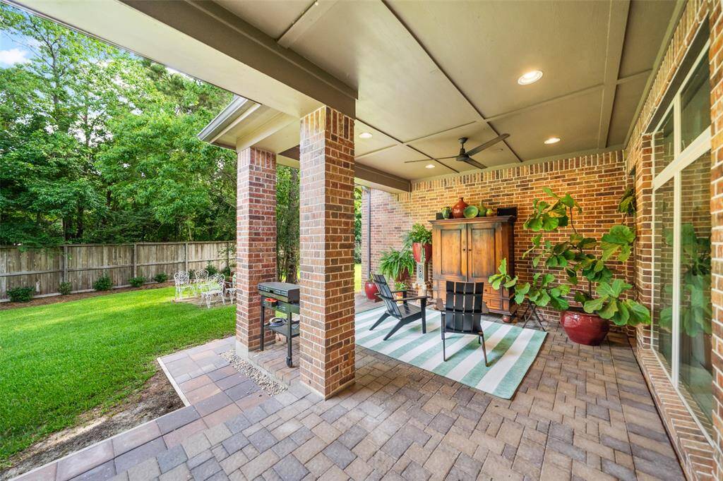 Lovely, covered patio area with 2 entrances into the home. One conveniently leads directly to powder room and Primary Suite area.