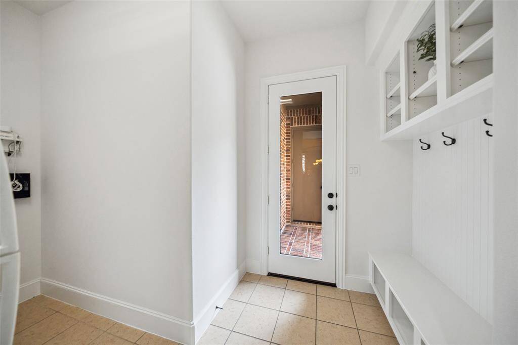 Utility room is conveniently adjacent to the mudroom with side door leading to outside parking and 3rd car garage.