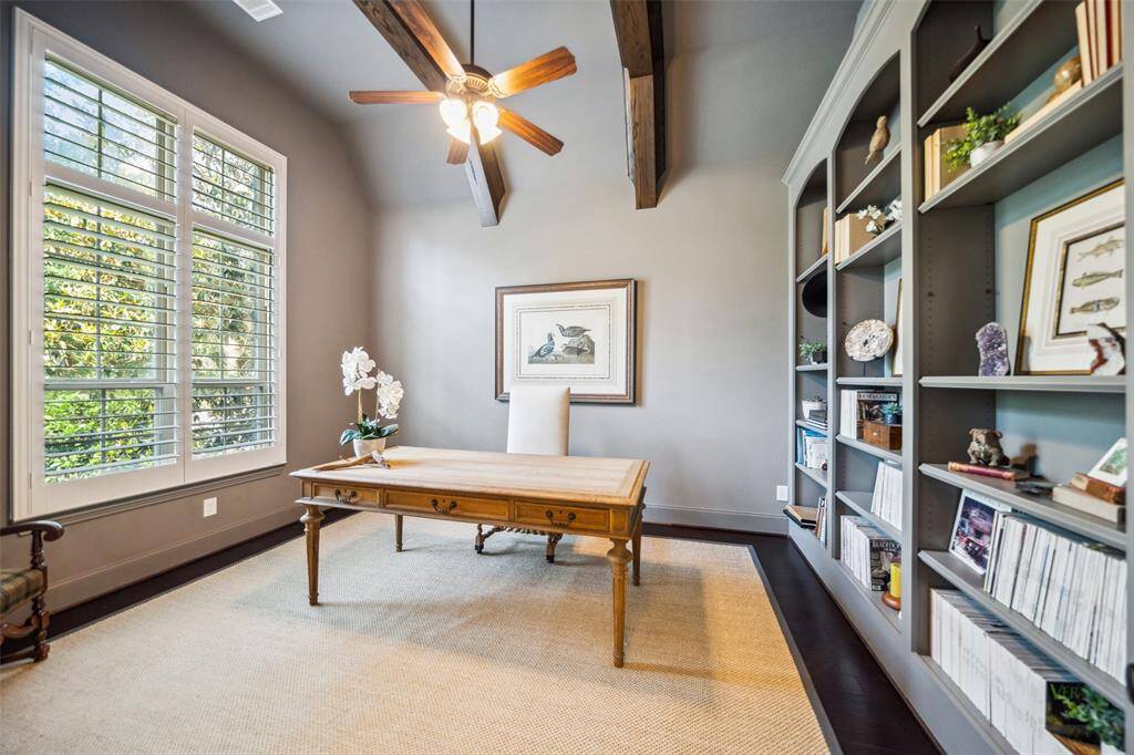 Step into the sophisticated study featuring an impressive wall of built-in bookshelves.