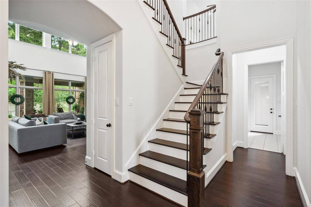 Elegant staircase with rich wood flooring.