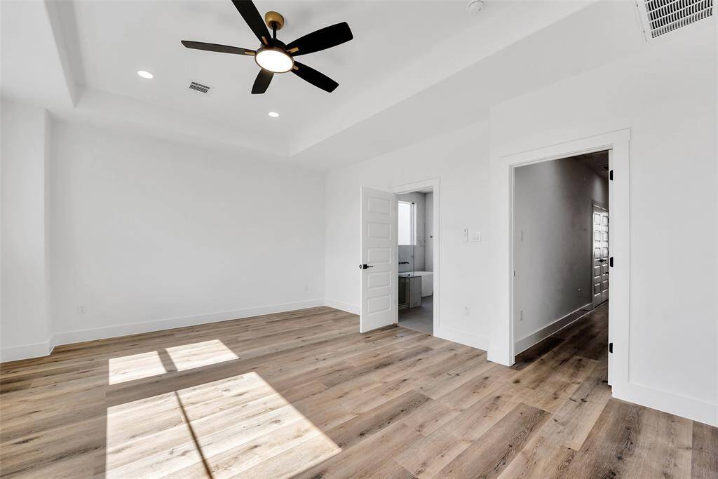 The primary suite boasts recessed ceiling, no carpet, a serene full bath and a walk-in closet.