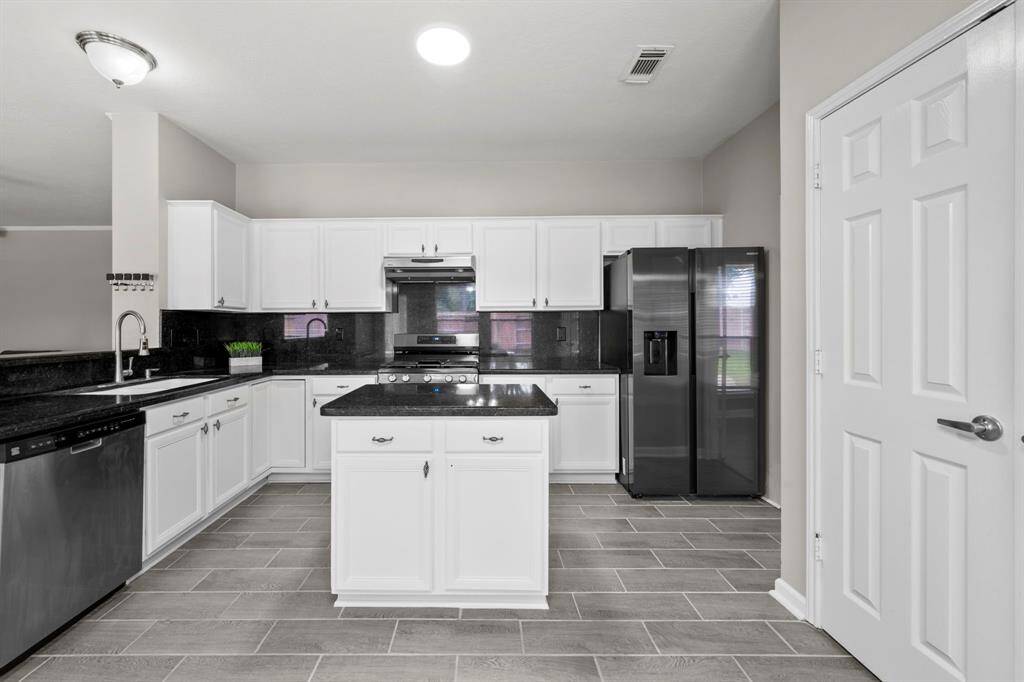 The home offers a spacious and practical kitchen which includes SS appliances, granite countertops, kitchen island, breakfast bar, plenty of storage and countertop space.