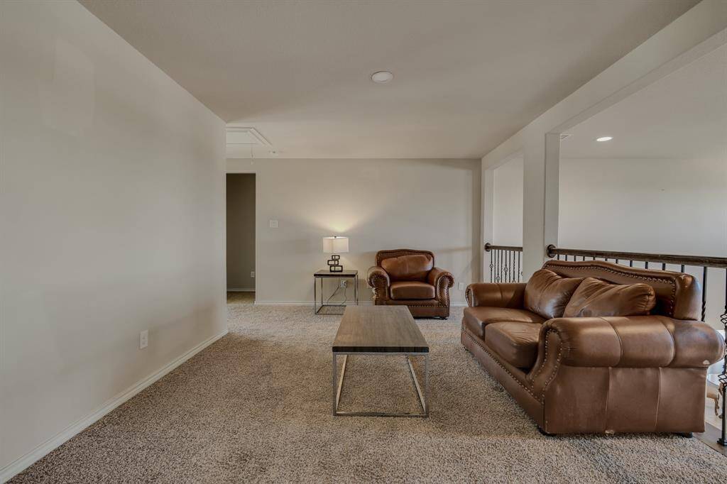 The room is well-lit, with a table lamp adding a warm ambiance.