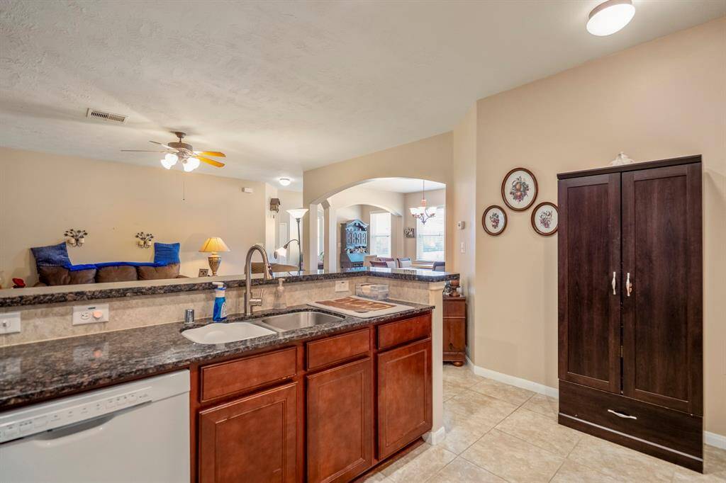 The kitchen is spacious and has plenty of cabinet storage space.