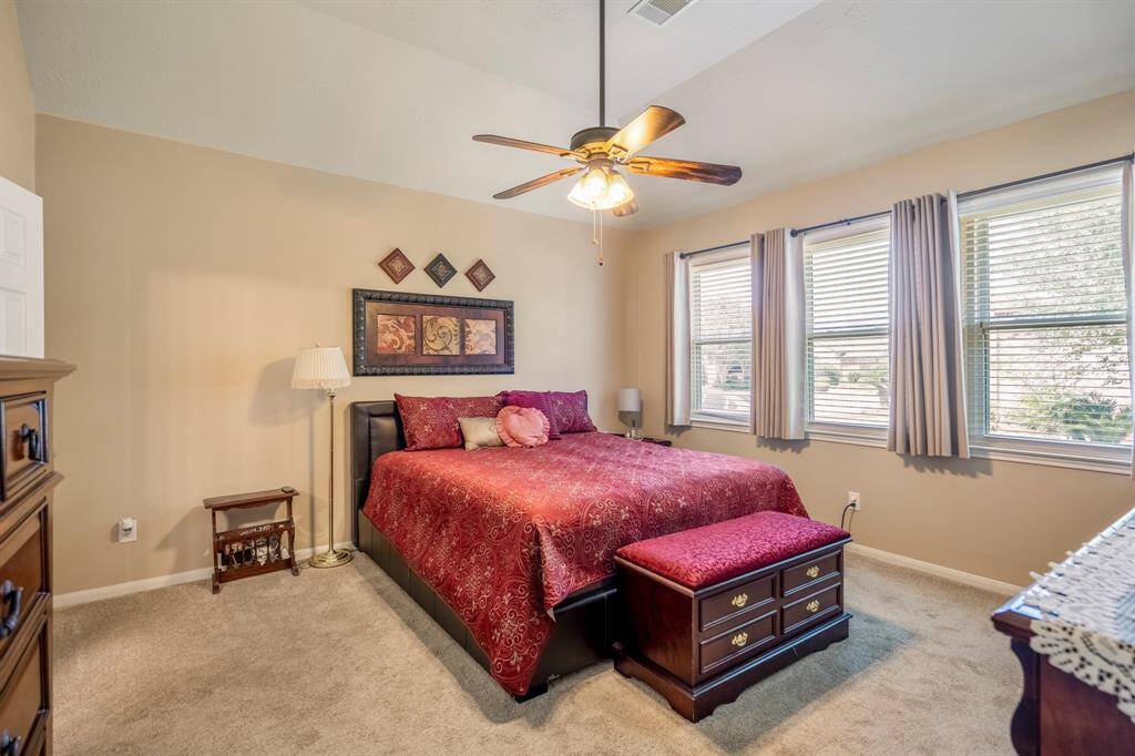 A large spacious primary bedroom suite with lots of natural light as well as overhead lighting.