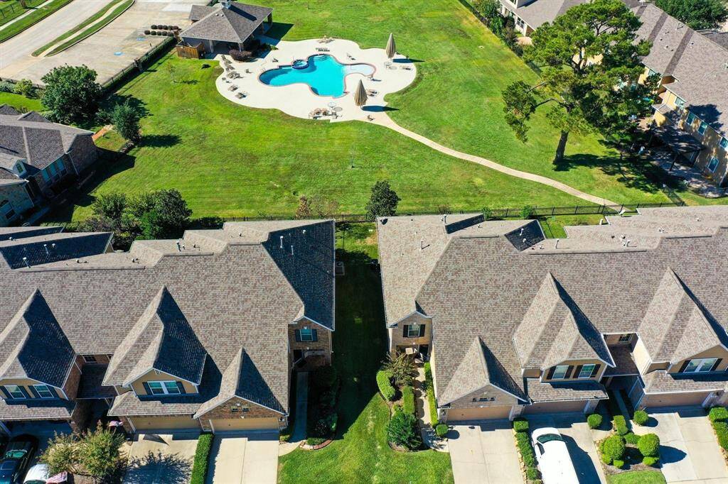 An aerial view of the green space with the pool that the residents get to enjoy.
