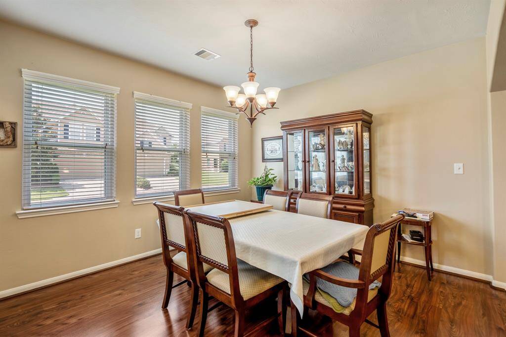 The dining area is surrounded by large windows that stream in natural light.