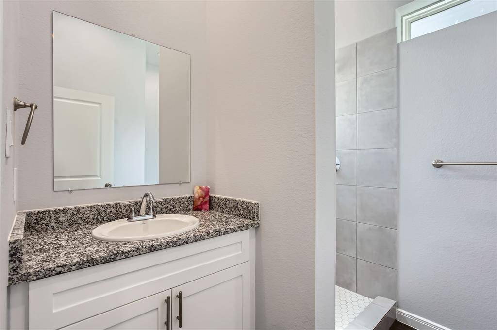 Secondary bathroom has granite countertops