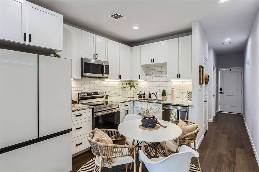 The beautful kitchen is enhanced by all stainless steel appliances, under-cabinet lighting and plenty of cabinets with upgraded hardware.