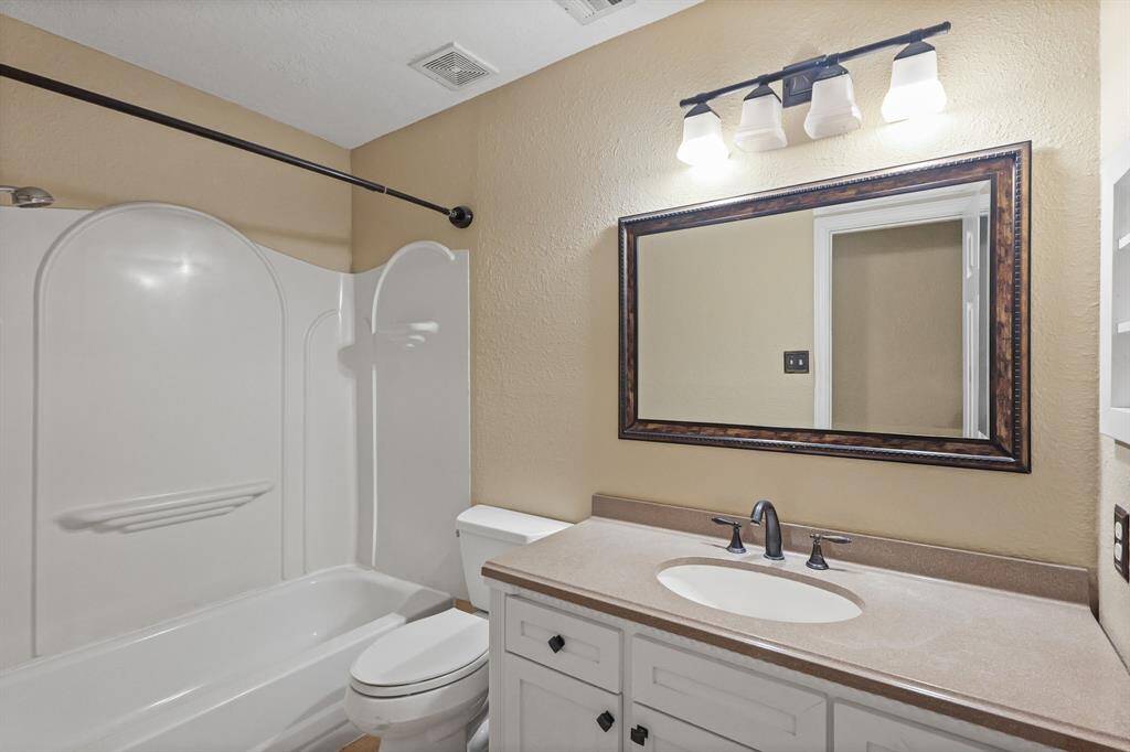Updated secondary bathroom with granite sink.