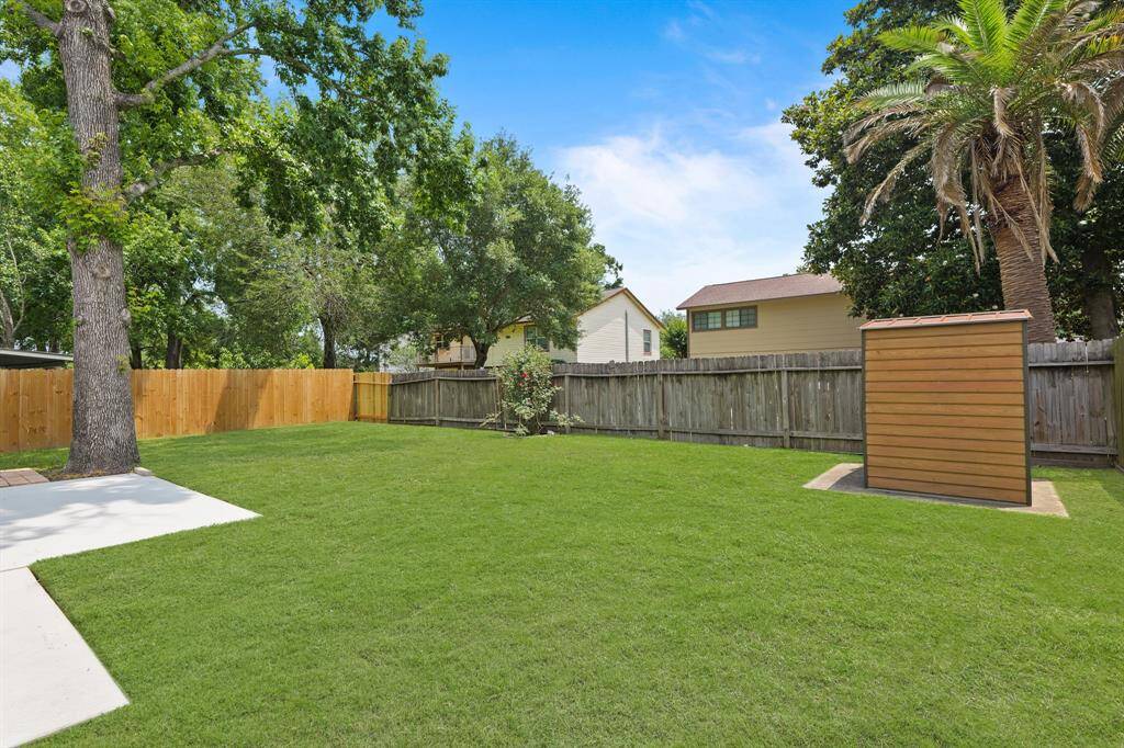 Large backyard with extended patio and additional storage.