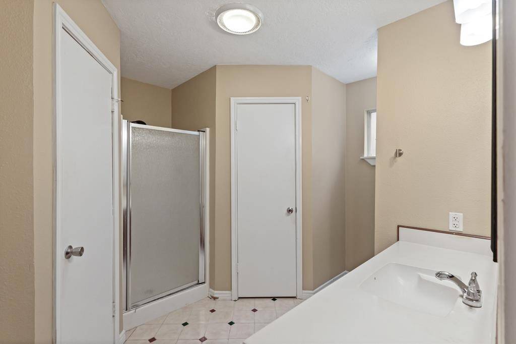 En suite bathroom features large shower and plenty of countertop space.