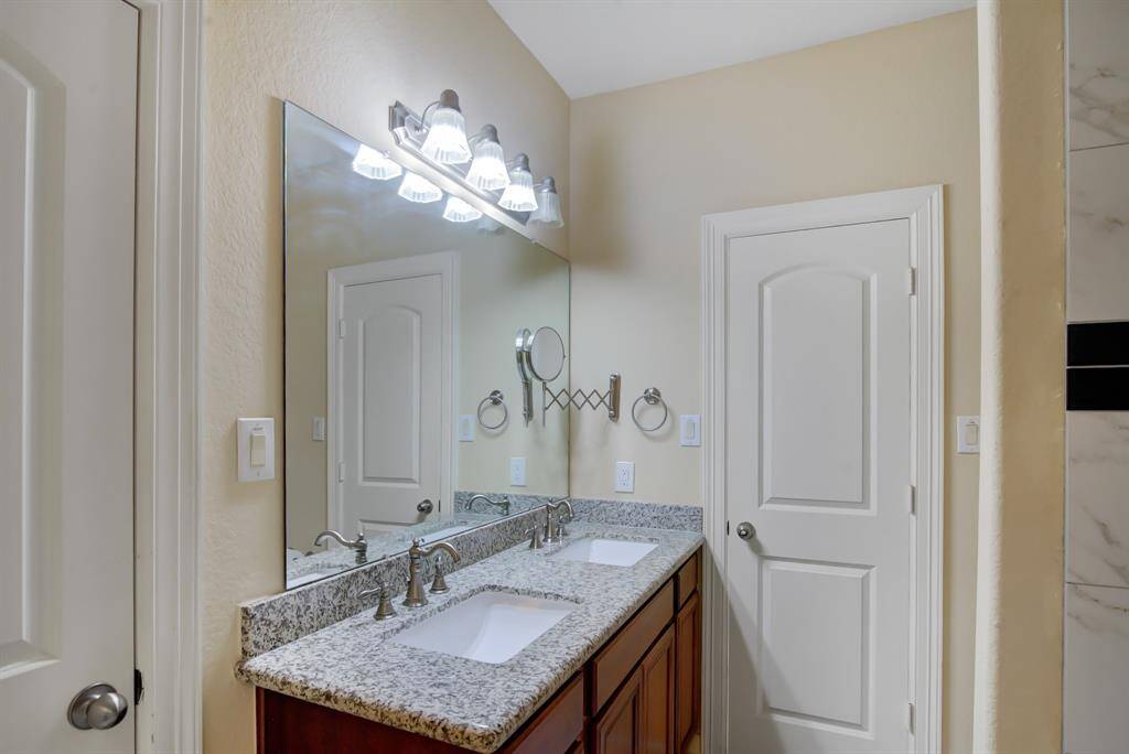 The dual entry bathroom can be accessed from both rooms and it has a spacious dual vanity with plenty of counter space and storage cabinets.