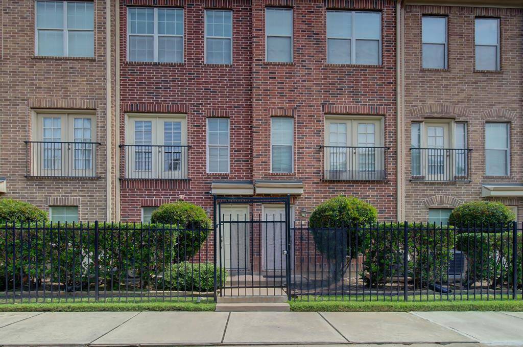 The property is fully gated and the front yard is adorned with lush landscaping. It's a highly walkable area with a cozy neighborhood vibe.