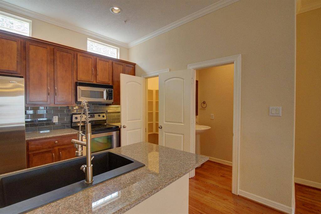 There's undermount lights, plenty of cabinets, above cabinet storage, and tons of counter space. Oh, and that walk-in closet!