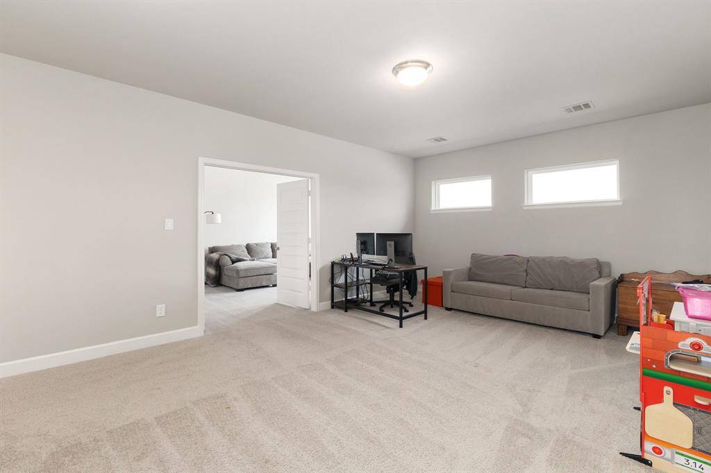 The upstairs game room is a versatile and spacious area, ideal for a variety of activities—whether it's hosting lively game nights, setting up a hobby or craft station, or transforming it into a fun and functional retreat for the kids.