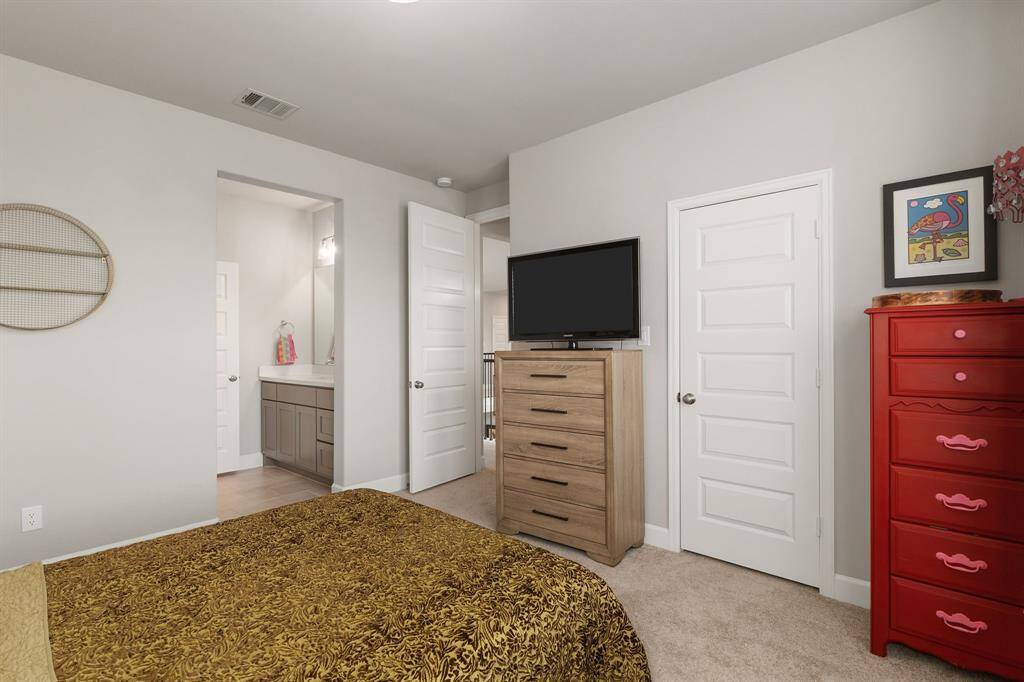 This final spacious secondary bedroom also includes a walk-in closet and convenient access to a Jack and Jill bathroom, combining comfort and practicality for family or guests.
