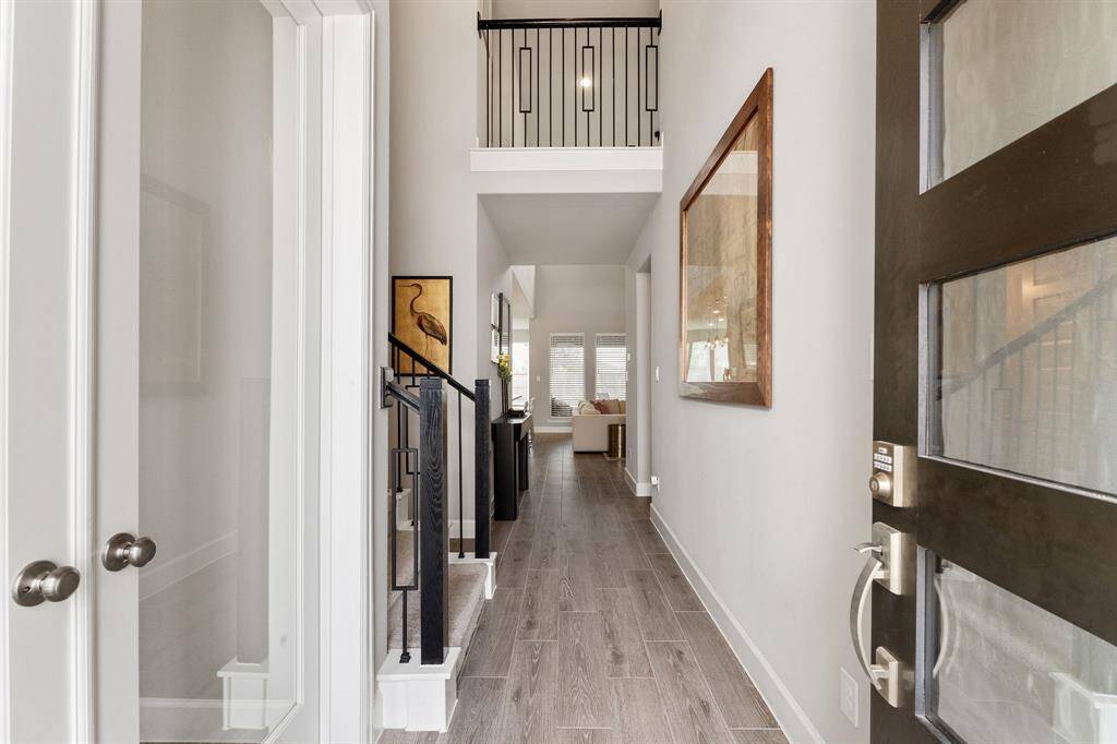 From the moment you enter, you'll be captivated by the gleaming wood-look tile floors, soaring ceilings, neutral paint palette, and stylish modern touches that set the tone for the rest of the home.