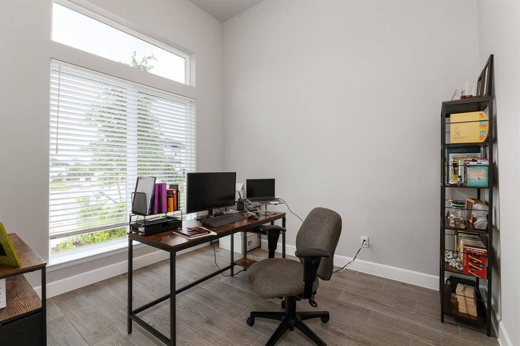 Just off the entry, behind elegant French glass doors, you'll find a private home office featuring tile flooring and a large window with a view of the front yard.