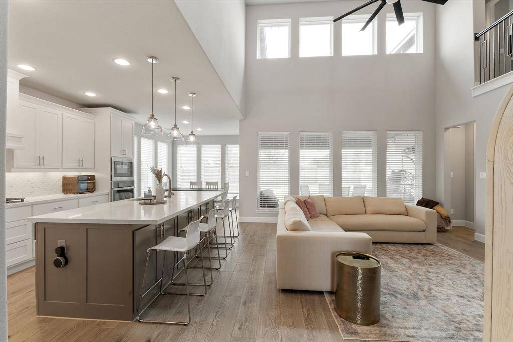 The open-concept floorplan effortlessly connects the family room, kitchen, and dining area, creating a spacious and inviting atmosphere. Expansive windows fill the home with an abundance of natural light.