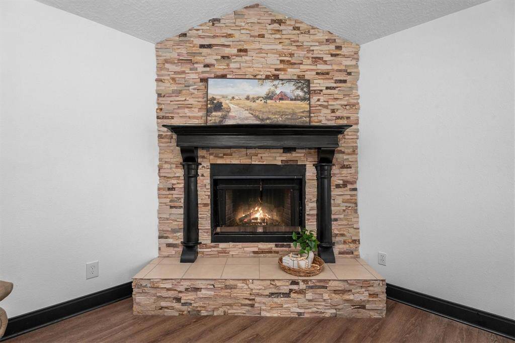 At the heart of the living area is a stunning new floor-to-ceiling stacked stone fireplace, adding a rugged, natural element that anchors the space with warmth and character.