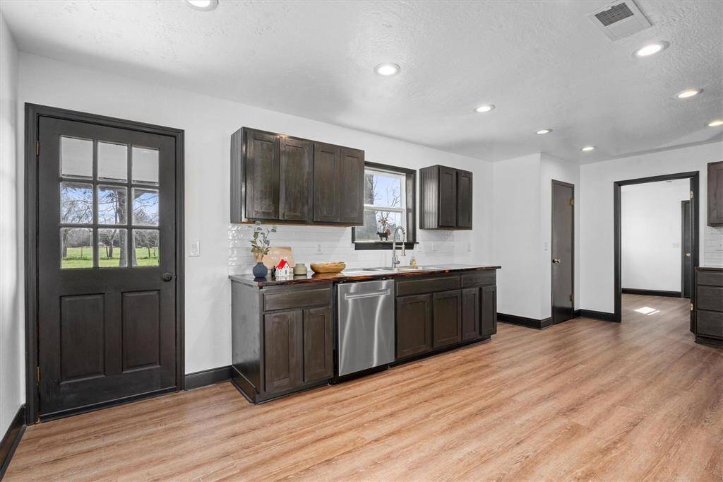The chef in your family will love this completely remodeled kitchen! New lighting, custom built dark cabinets that our highlighted by a white backsplash abd custom made countertops,and new faucet.