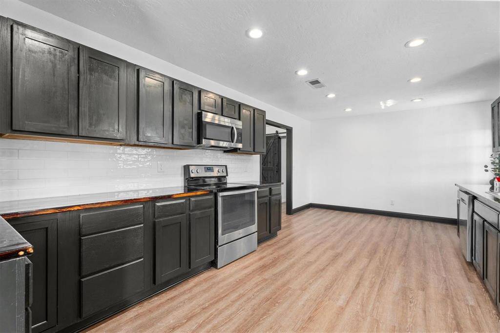 You will LOVE all the storage and counter space in this kitchen! Electric Cooktop! This is walking in from the Utility Room.