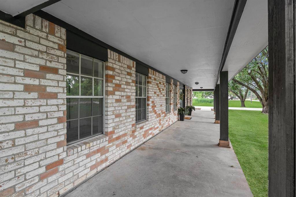 Stretching across the front of the home, the covered porch adds charm and provides a shaded space to enjoy the outdoors year-round.