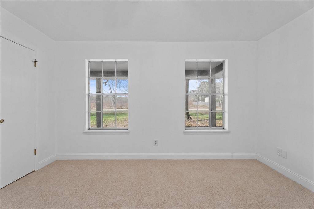 Primary suite looking out to the serene front yard.