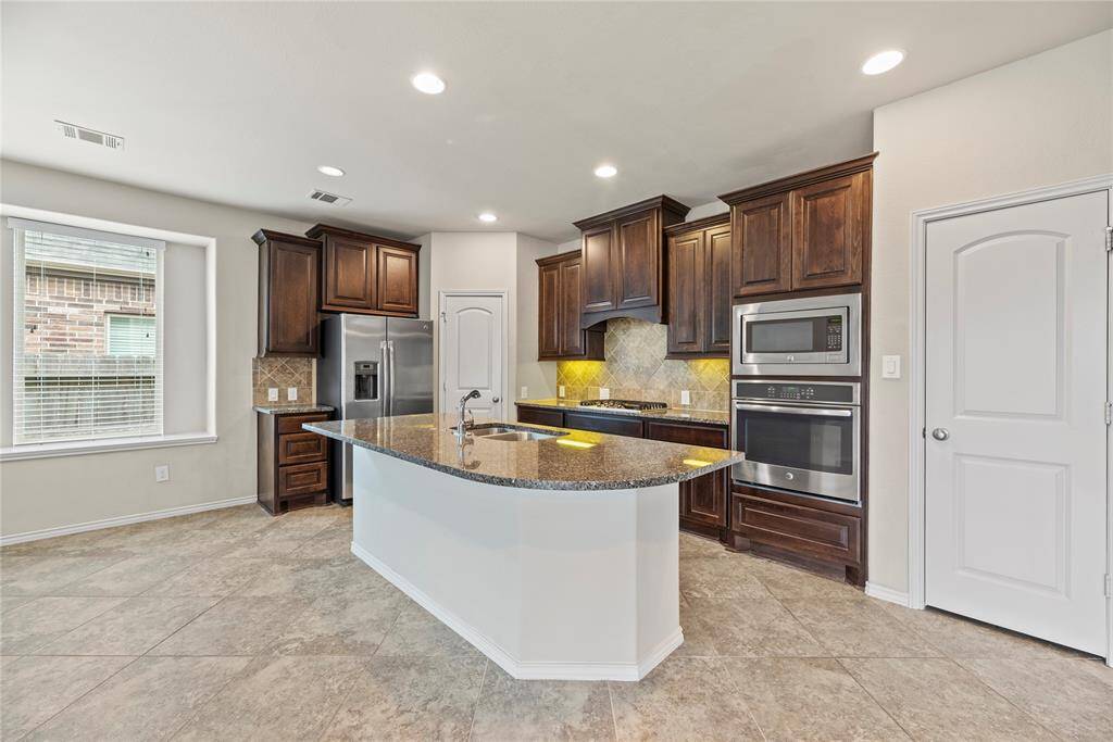 The kitchen features a spacious island with built-in seating, ideal for casual dining or entertaining guests.