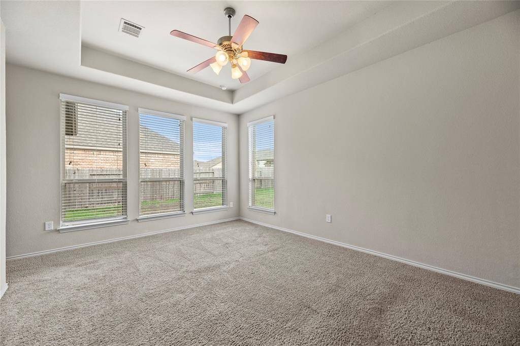 Primary bedroom is complete with a lofty 10-foot ceiling, offering a serene oasis for relaxation.